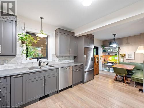 Kitchen in upper unit (2nd flr). Miele dishwasher, restoration hardware lighting - 213 Caroline Street S, Hamilton, ON 