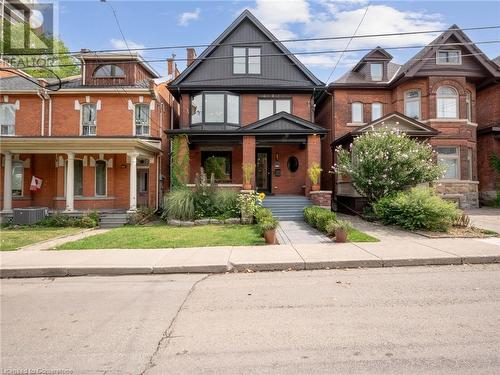 All-brick century home with some vinyl siding accent - 213 Caroline Street S, Hamilton, ON - Outdoor With Deck Patio Veranda With Facade