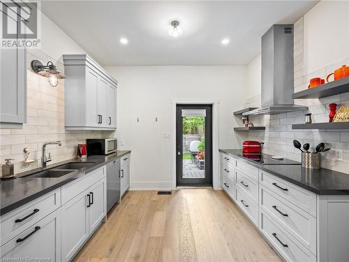 Kitchen on main-floor: new exterior door (2018) leading to backyard - 213 Caroline Street S, Hamilton, ON - Indoor Photo Showing Kitchen With Double Sink