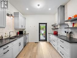 Kitchen on main-floor: new exterior door (2018) leading to backyard - 