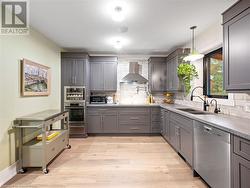 Kitchen in upper unit (2nd flr). Soft close cabinetry including hidden garbage/recycling and designated spice drawer! - 