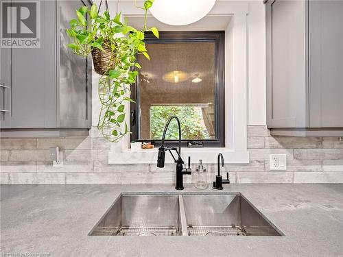 Kitchen in upper unit (2nd flr). Double undermount sink, large window (all windows replaced in 2018) overlooking deck/backyard - 213 Caroline Street S, Hamilton, ON - Indoor Photo Showing Kitchen With Double Sink