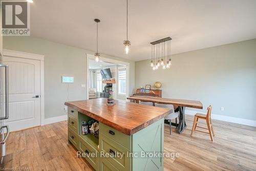 Stairway with a wood stove and wood-type flooring - 82 Sunview Drive, Norwich, ON - Indoor With Fireplace