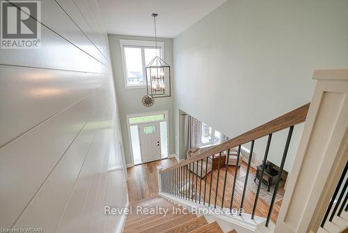 Kitchen with white cabinets, light hardwood / wood-style floors, premium appliances, and premium range hood - 82 Sunview Drive, Norwich, ON - Indoor Photo Showing Kitchen With Upgraded Kitchen