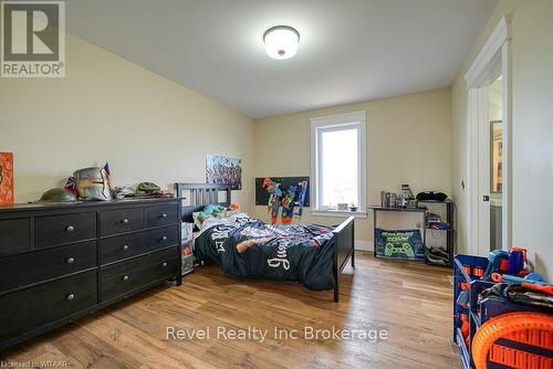 Kitchen with a kitchen island, wooden counters, green cabinetry, pendant lighting, and light hardwood / wood-style flooring - 82 Sunview Drive, Norwich, ON - Indoor