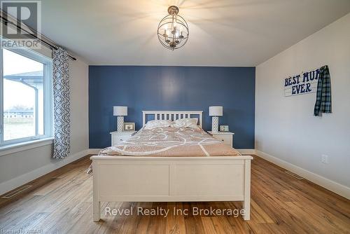 Entryway with a high ceiling, hardwood / wood-style floors, and a notable chandelier - 82 Sunview Drive, Norwich, ON - Indoor Photo Showing Other Room