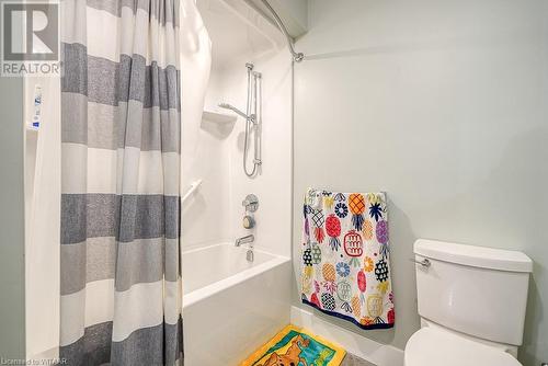 Bathroom featuring toilet and shower / bath combo with shower curtain - 82 Sunview Drive, Norwich, ON - Indoor Photo Showing Bathroom