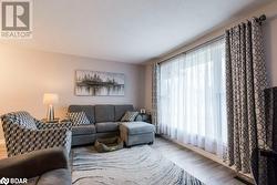 Living room featuring plenty of natural light and light hardwood / wood-style floors - 