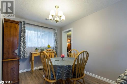 Dining space featuring dark hardwood / wood-style flooring, a notable chandelier, and a textured ceiling - 262 Barrett Boulevard, Napanee, ON - Indoor Photo Showing Dining Room