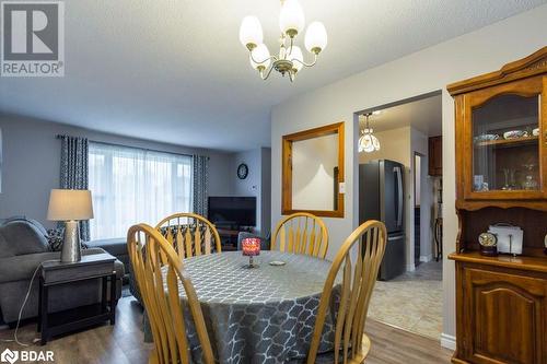 Dining room featuring dark wood-type flooring, a textured ceiling, and an inviting chandelier - 262 Barrett Boulevard, Napanee, ON - Indoor Photo Showing Dining Room