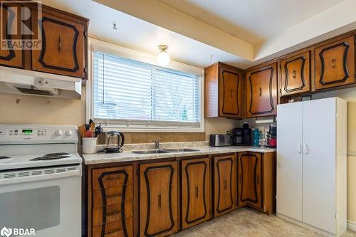 Kitchen with sink and white range with electric cooktop - 262 Barrett Boulevard, Napanee, ON - Indoor Photo Showing Kitchen With Double Sink