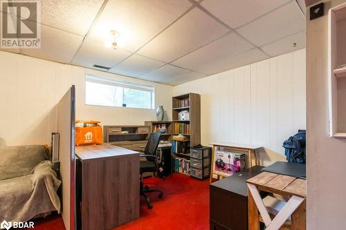 Office area featuring a drop ceiling, carpet flooring, and wooden walls - 262 Barrett Boulevard, Napanee, ON - Indoor Photo Showing Office