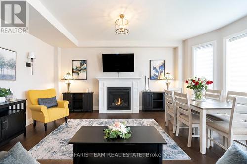 135 Ritchie Crescent, Springwater, ON - Indoor Photo Showing Living Room With Fireplace