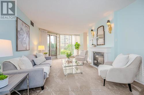 406 - 55 Kingsbridge Garden Circle, Mississauga, ON - Indoor Photo Showing Living Room With Fireplace