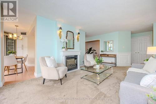 406 - 55 Kingsbridge Garden Circle, Mississauga, ON - Indoor Photo Showing Living Room With Fireplace