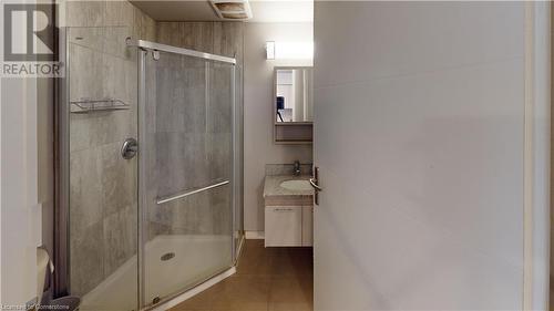 Bathroom with tile patterned flooring, vanity, and a shower with shower door - 308 Lester Street Unit# 215, Waterloo, ON - Indoor Photo Showing Bathroom