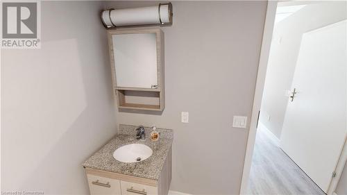 Bathroom featuring hardwood / wood-style flooring and vanity - 308 Lester Street Unit# 215, Waterloo, ON - Indoor