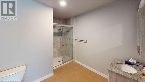 Bathroom with tile patterned flooring, an enclosed shower, vanity, and toilet - 308 Lester Street Unit# 215, Waterloo, ON - Indoor Photo Showing Bathroom