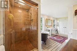 Primary ensuite with walk-in shower and separate tub with a view.  Lots of storage. - 