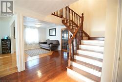 Staircase with hardwood / wood-style floors - 