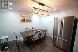 Dining area featuring dark wood-type flooring - 