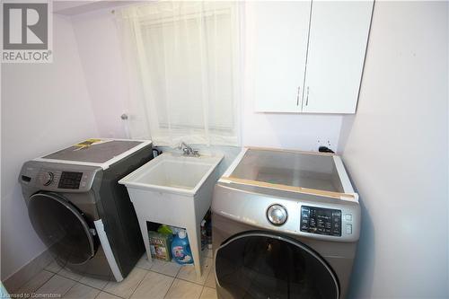 Laundry room with light tile patterned floors and sink - 30 Kristi Place, Kitchener, ON - Indoor Photo Showing Laundry Room