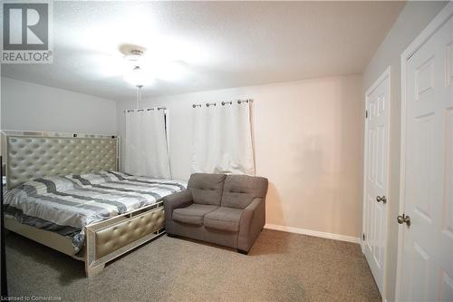 Carpeted bedroom with a textured ceiling and ceiling fan - 30 Kristi Place, Kitchener, ON - Indoor Photo Showing Bedroom