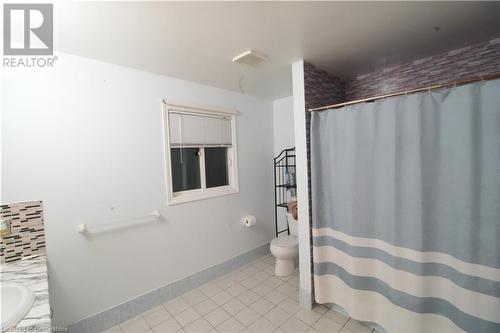 Bathroom with toilet, decorative backsplash, vanity, and tile patterned floors - 30 Kristi Place, Kitchener, ON - Indoor Photo Showing Bathroom