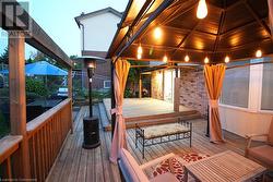 Deck at dusk featuring a gazebo - 