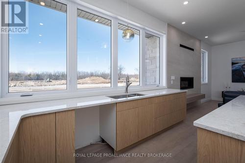 158 Summerside Drive, South Frontenac, ON - Indoor Photo Showing Kitchen With Fireplace With Double Sink