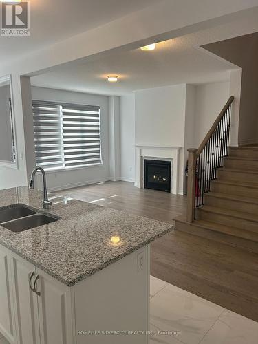 4 Kingsbury Trail, Barrie, ON - Indoor Photo Showing Kitchen With Fireplace With Double Sink