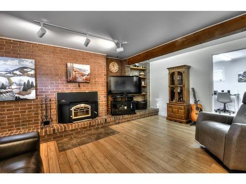 Family room - 4050 Av. Maupassant, Brossard, QC - Indoor Photo Showing Living Room With Fireplace