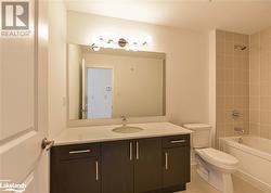 Full bathroom featuring vanity, toilet, and tiled shower / bath - 