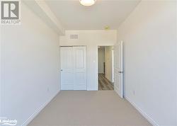 Unfurnished bedroom featuring carpet floors and a closet - 