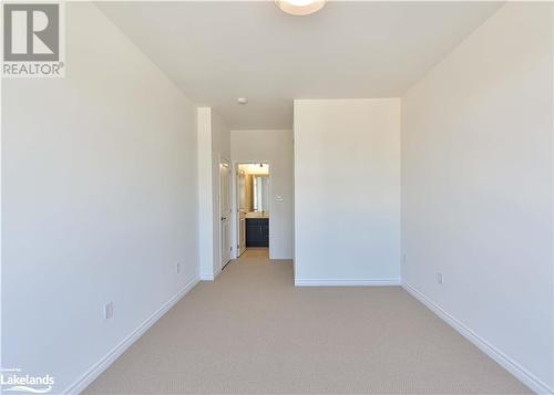 View of carpeted empty room - 25 Wyn Wood Lane, Orillia, ON - Indoor Photo Showing Other Room