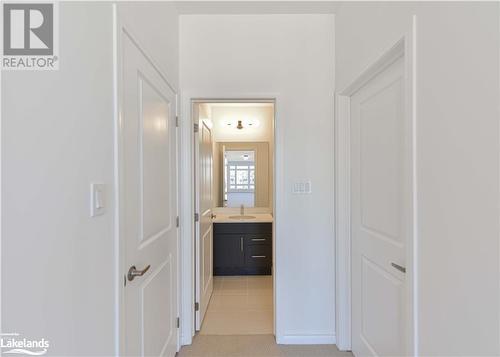 Corridor featuring light tile patterned flooring and sink - 25 Wyn Wood Lane, Orillia, ON - Indoor Photo Showing Other Room