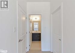 Corridor featuring light tile patterned flooring and sink - 