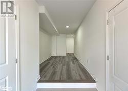 Hallway with dark hardwood / wood-style flooring - 