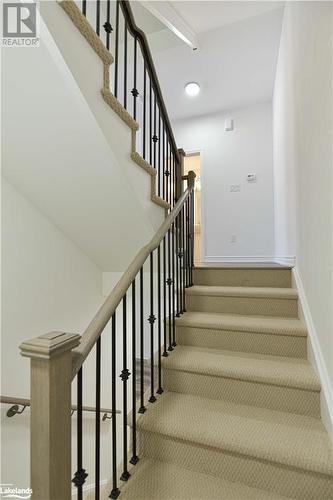 Stairs featuring carpet flooring - 25 Wyn Wood Lane, Orillia, ON - Indoor Photo Showing Other Room