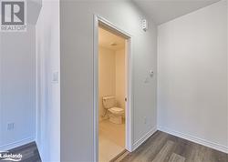 Hallway featuring dark hardwood / wood-style flooring - 