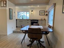 Dining area featuring wood ceiling, sink, and light wood-type flooring - 