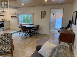 Living room with wood ceiling and light wood-type flooring - 