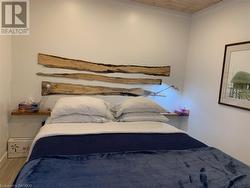 Bedroom with hardwood / wood-style floors and wood ceiling - 