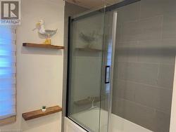 Bathroom with combined bath / shower with glass door - 