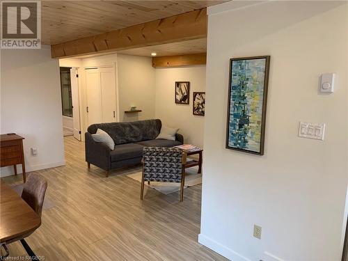 Living room featuring light wood-style flooring, beam ceiling, and wooden ceiling - 2 John Street, Lions Head, ON - Indoor