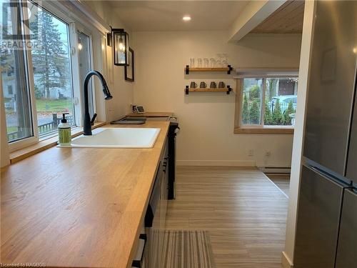 Kitchen featuring Large sink, butcher block countertops and stainless steel fridge - 2 John Street, Lions Head, ON - Indoor