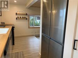 Kitchen with stainless steel appliances, wooden counters, sink - 