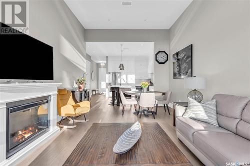 312 408 Cartwright Street, Saskatoon, SK - Indoor Photo Showing Living Room With Fireplace