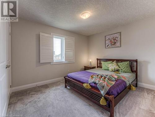 Carpeted bedroom featuring a textured ceiling - 14 Greyhawk Street, Kitchener, ON - Indoor Photo Showing Bedroom