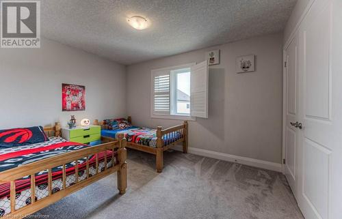 Bedroom with a textured ceiling and light carpet - 14 Greyhawk Street, Kitchener, ON - Indoor Photo Showing Bedroom